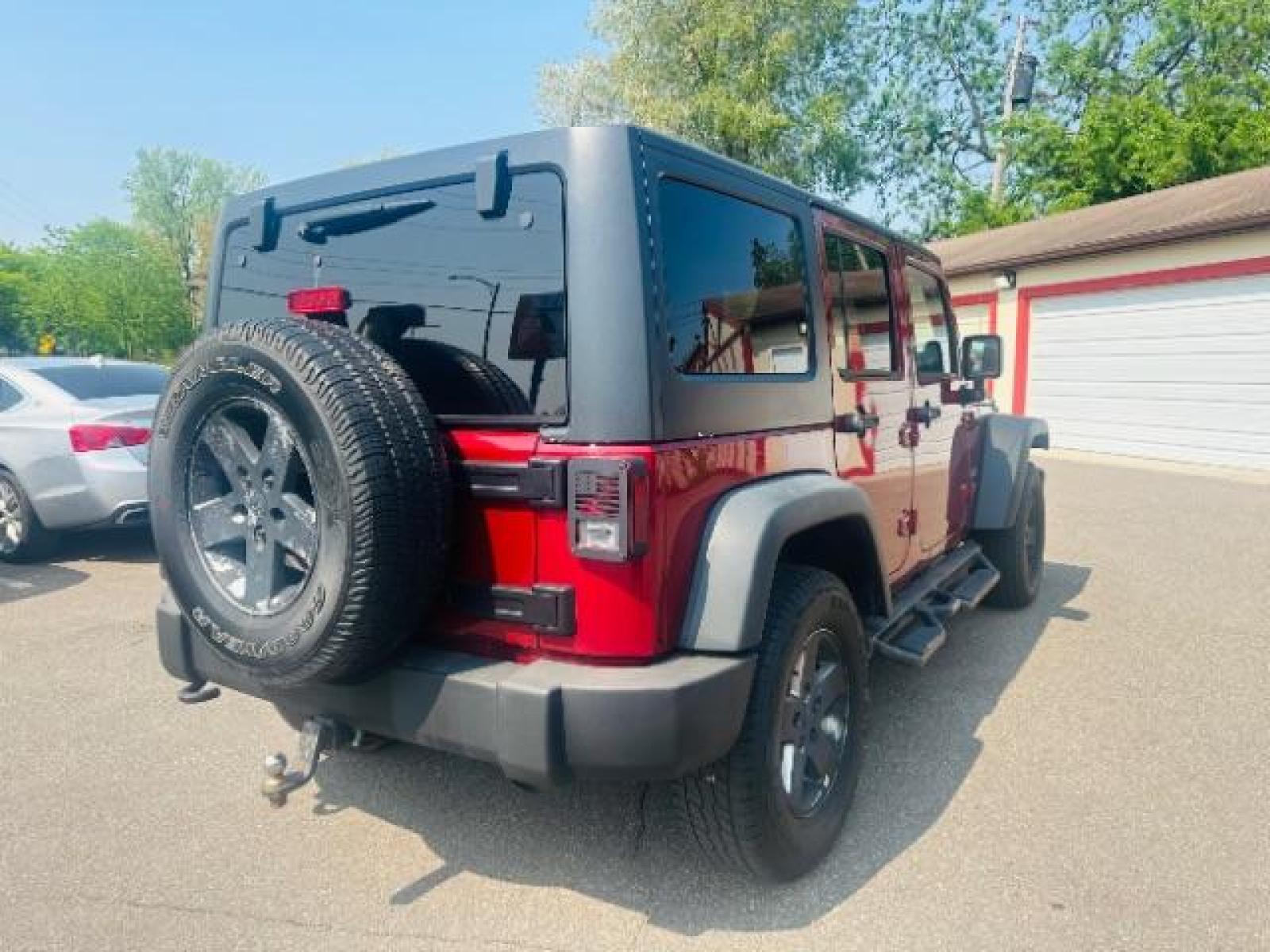 2011 Deep Cherry Red Crys Jeep Wrangler Unlimited Sport 4WD (1J4BA3H15BL) with an 3.8L V6 OHV 12V engine, located at 834 West 7th Street, St. Paul, MN, 55102, (651) 797-6393, 44.930954, -93.121559 - Photo #4