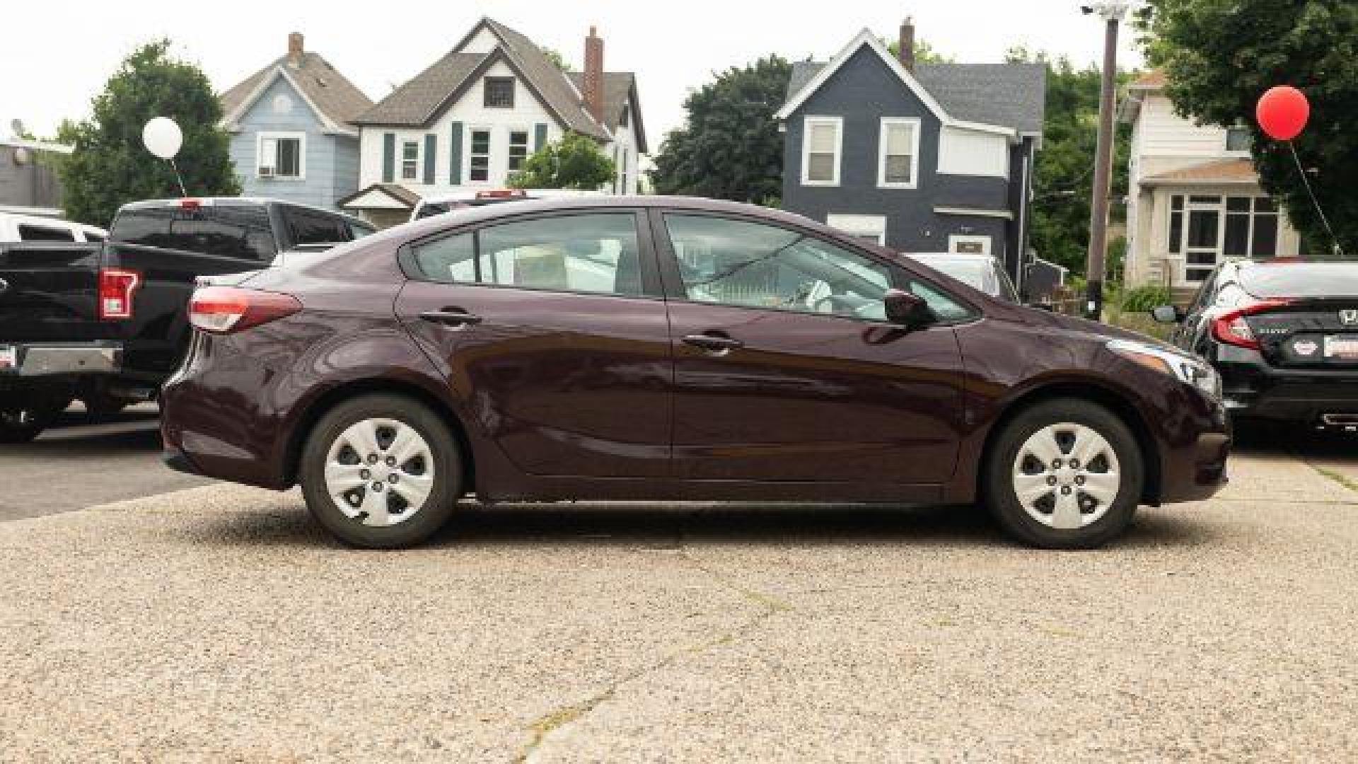 2017 Garnet Red Kia Forte LX 6A (3KPFL4A72HE) with an 2.0L L4 DOHC 16V engine, 6-Speed Automatic transmission, located at 745 S Robert St, St. Paul, MN, 55107, (651) 222-2991, 44.923389, -93.081215 - Photo#2