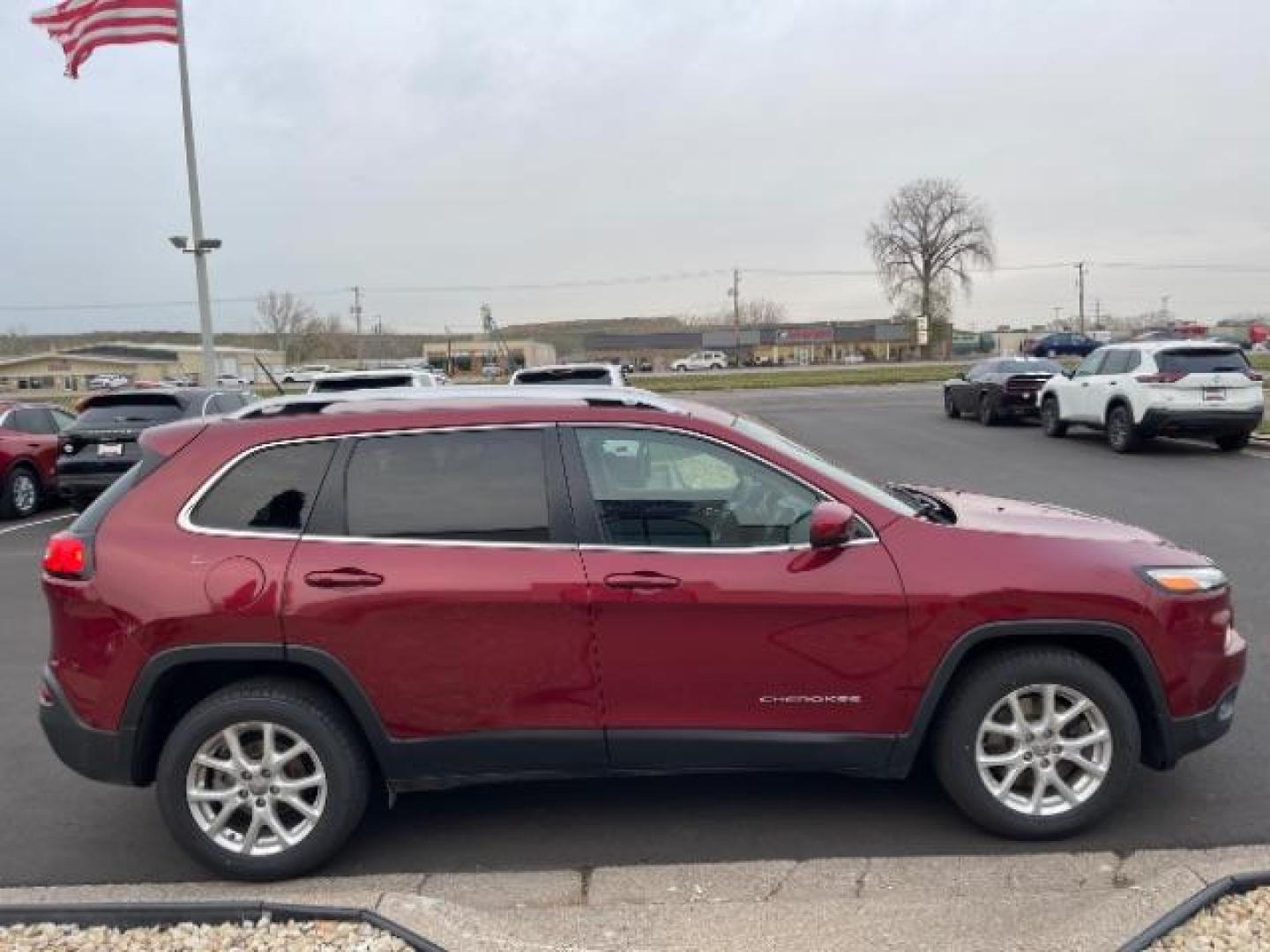 2016 Deep Cherry Red Crystal Pearl Coat Jeep Cherokee Latitude FWD (1C4PJLCB1GW) with an 2.4L L4 DOHC 16V engine, 9-Speed Automatic transmission, located at 3301 W Hwy 13, Burnsville, MN, 55337, (952) 460-3200, 44.775333, -93.320808 - Photo#6