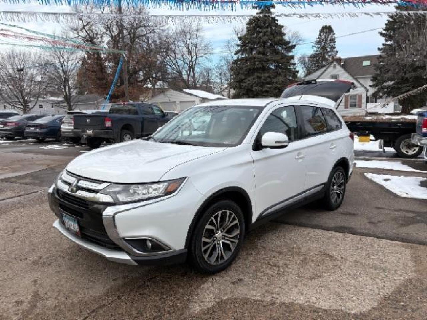 2016 Diamond White Mitsubishi Outlander SE AWD (JA4AZ3A32GZ) with an 2.4L L4 DOHC 16V engine, Continuously Variabl transmission, located at 745 S Robert St, St. Paul, MN, 55107, (651) 222-2991, 44.923389, -93.081215 - Photo#1