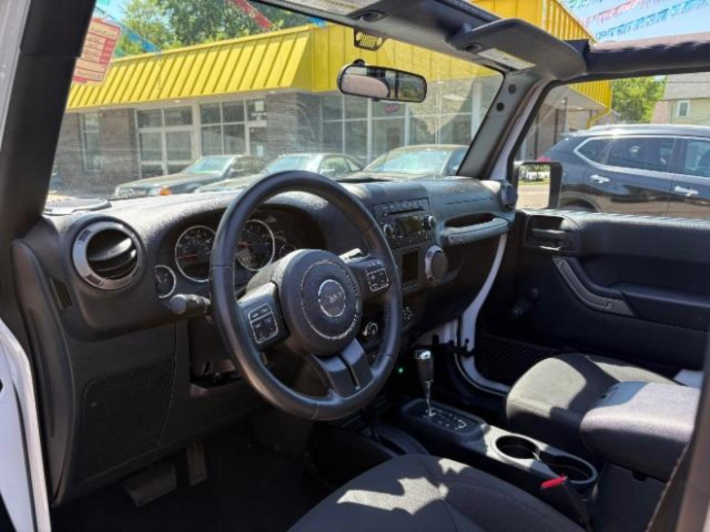 2016 Bright White Clearcoat Jeep Wrangler Unlimited Sport (1C4BJWDG5GL) with an Pentastar 3.6L V-6 DOHC engine, located at 745 S Robert St, St. Paul, MN, 55107, (651) 222-2991, 44.923389, -93.081215 - Photo#12